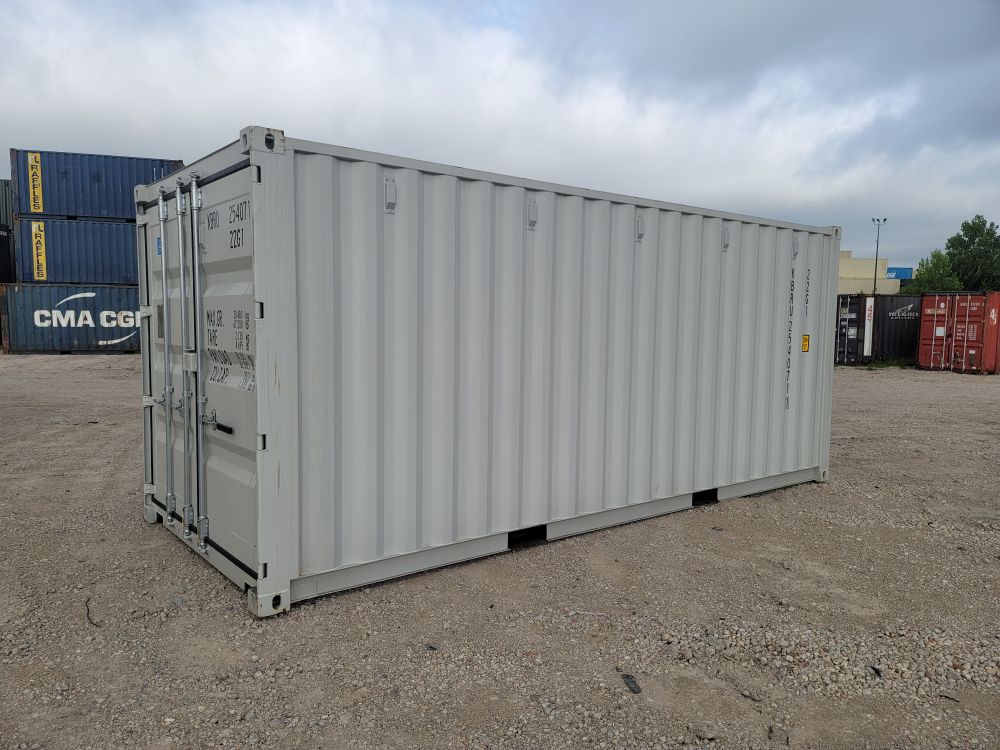 A shipping container being placed on-site by an LC Container delivery truck